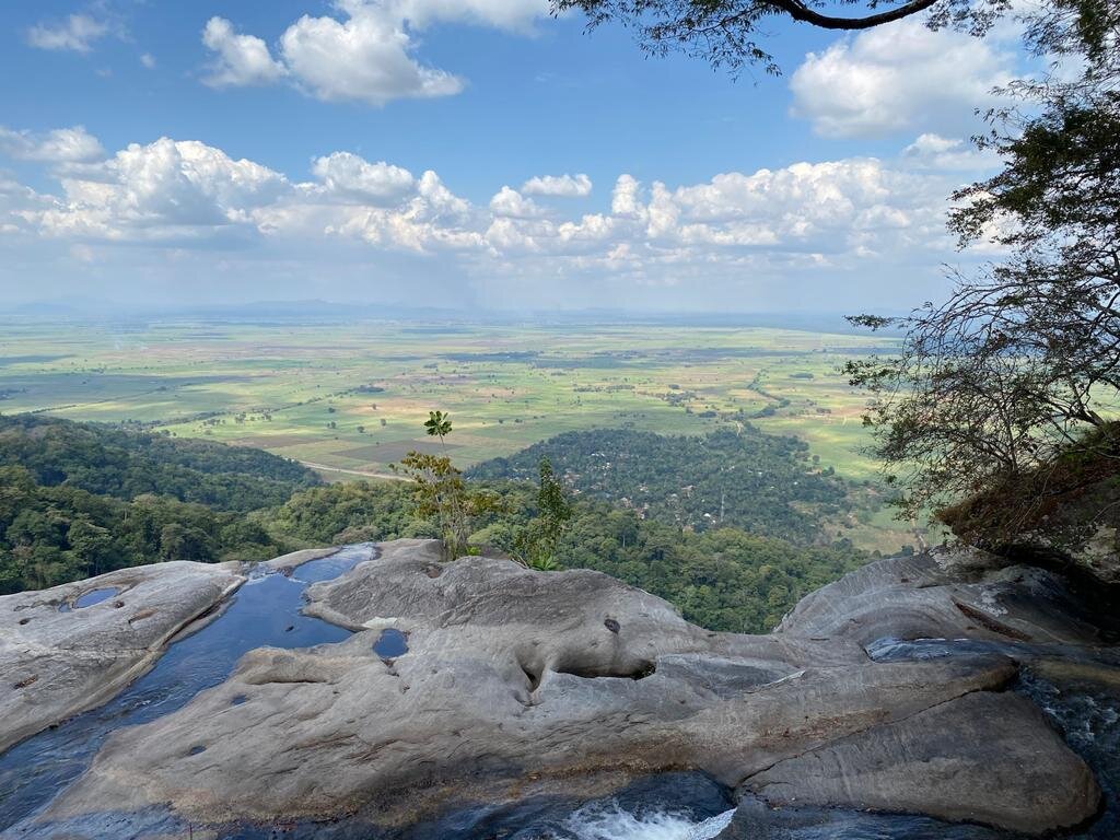 Bare rock slabs at the top of the falls overlooking farmland plains, Udzungwa Mountains National Park