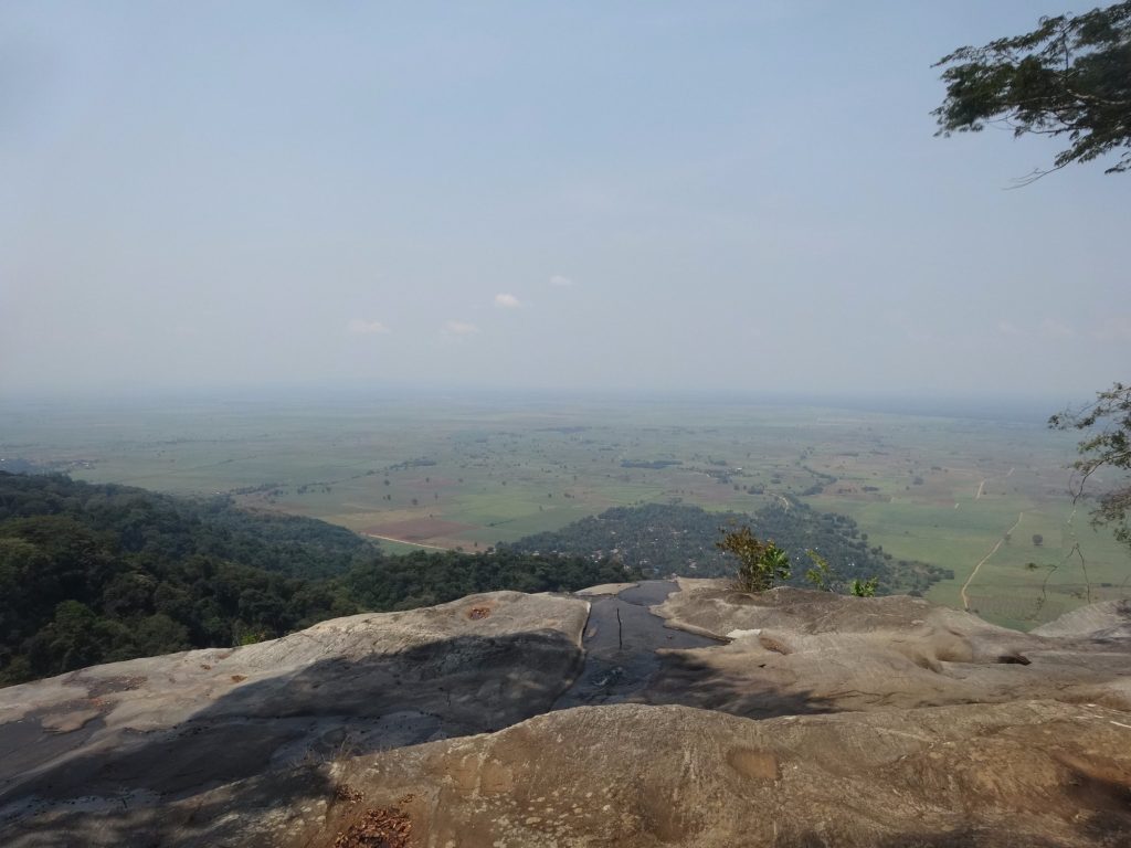 Hazy plains view from a clifftop rock slab, Udzungwa Mountains National Park