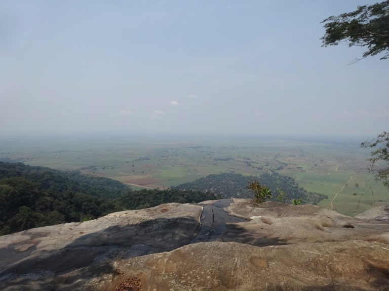 Hazy plains view from a clifftop rock slab, Udzungwa Mountains National Park