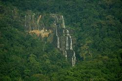 Tall falls seen across a forested hillside, Udzungwa Mountains National Park