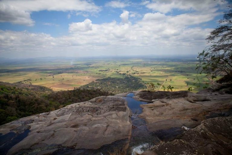 View from a rock ledge over the farmland plain, Udzungwa Mountains National Park