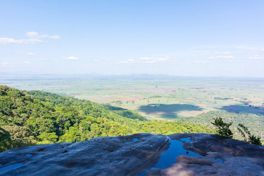 View over green plains from wet rock slabs, Udzungwa Mountains National Park
