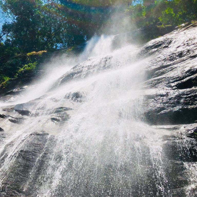 Waterfall spraying over dark granite slabs, Udzungwa Mountains National Park